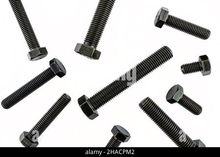 Background made of black screws with a hardness of 4.8, isolated on a white background, visible small and large screws, top view. Stock Photo