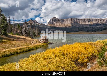 Breccia Cliffs, Sublette Peak on left, fall color bushes at Brooks Lake, Absaroka Range, Rocky Mountains, Shoshone National Forest, Wyoming, USA Stock Photo