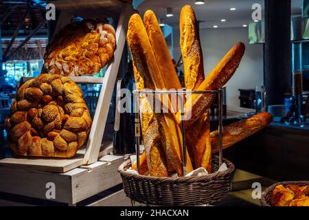 Loaves of bread in bakery. Different types of fresh bread on the table. High quality photo Stock Photo