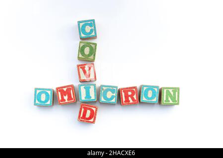 covid and omicron spelled out in old children's letters building blocks Stock Photo