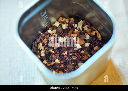 Dried tea leaves in metal bowl. Dried herbs tea leaves close up. Different dry herbs and flowers for making healthy tea background. Stock Photo
