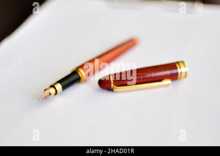 The fountain pen is lying on the paper. Close up. Macro Stock Photo