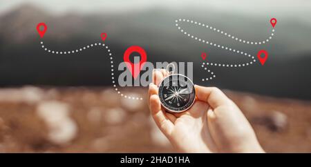 Traveler hand holds a compass on the beautiful Carpathian mountains during vacation. Horizontal banner with place for text. Technology interenet and t Stock Photo