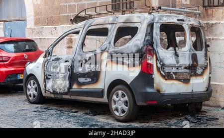 Burned car. the remains of a fire damaged Renault Kangoo a  multi purpose commercial vehicle. Photographed in Jaffa, Israel Stock Photo