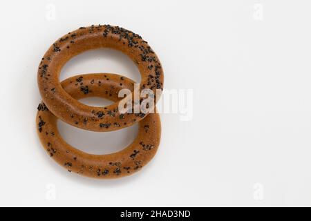 two whole bagels with poppy seeds isolated on white background, top view, food bakery concept Stock Photo