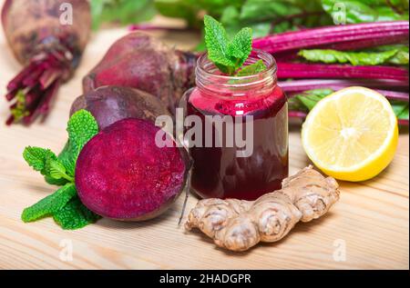 Red Beetroot, ginger and lemon smoothie on wooden Background. homemade detox drinks Stock Photo