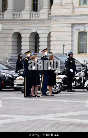 Washington, United States of America. 10 December, 2021. U.S. Chairman of the Joint Chiefs Gen. Mark Milley, former Senator Elizabeth Dole, Maj. Garrett Beer and Robin Dole render honors as Armed Forces honor guard carry the flag-draped casket of World War II veteran and former Senator Robert Dole out of the U.S. Capitol, December 10, 2021 in Washington, D.C. Senator Dole died at age 98 following a lifetime of service to the nation.  Credit: Leroy Council/U.S. Army/Alamy Live News Stock Photo