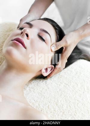 A woman receives a Purifying Facial, a 50-minute deep cleansing facial that uses flower essences, active clays, and plant extracts of lavender, lemon Stock Photo