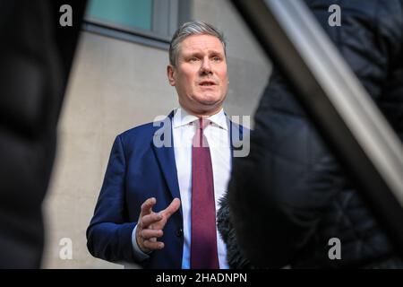 London, UK. 12th Dec, 2021. Sir Keir Starmer KCB QC MP, Leader of the Labour Party, exits the BBC headquarters in London and is interviewed, following an appearance at the Andrew Marr Show. Starmer reacted to the latest set of proposed covid measures, as well as PM Boris Johnson's stance on alleged Christmas parties at Downing Street and in several government departments. Credit: Imageplotter/Alamy Live News