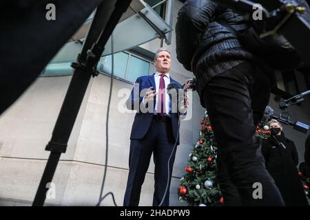 London, UK. 12th Dec, 2021. Sir Keir Starmer KCB QC MP, Leader of the Labour Party, exits the BBC headquarters in London and is interviewed, following an appearance at the Andrew Marr Show. Starmer reacted to the latest set of proposed covid measures, as well as PM Boris Johnson's stance on alleged Christmas parties at Downing Street and in several government departments. Credit: Imageplotter/Alamy Live News