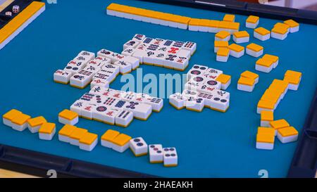 Many Mahjong tiles on the playing field. An ancient asian game called Mahjong as a way to spend your free time with joy and get some fun. Stock Photo