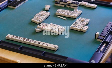 Many Mahjong tiles on on the playing field. An ancient asian game called Mahjong as a way to spend your free time with joy and get some fun. Mahjong t Stock Photo