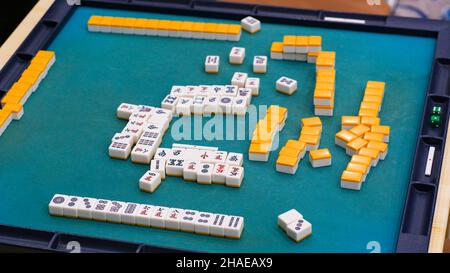 Many Mahjong tiles on on the playing field. An ancient asian game called Mahjong as a way to spend your free time with joy and get some fun. Mahjong t Stock Photo