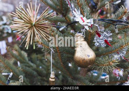 https://l450v.alamy.com/450v/2haed3r/painted-gold-old-light-bulb-and-handmade-aluminium-foil-decoration-on-christmas-tree-diy-creative-ideas-environment-recycle-reuse-upcycling-zero-waste-electricity-concept-selective-focus-2haed3r.jpg