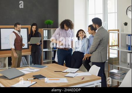 Diverse businessmen having fun, creative thinking at team briefing in office Stock Photo