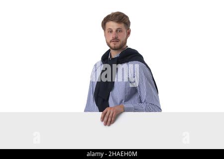 Young stylish casual business man behind a blank sign banner isolated on white background Stock Photo