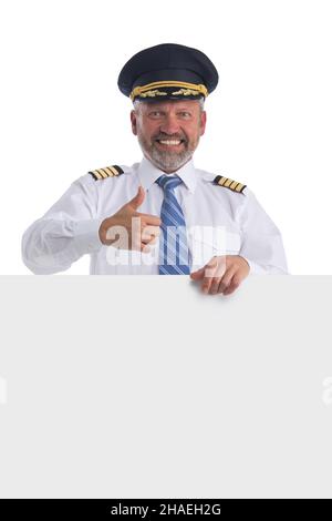 Portrait of happy smiling pilot holds blank banner isolated on white background Stock Photo