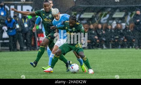 Portland, USA. 11th Dec, 2021. New York's Santiago Rodriguez tries to dispoosess Portland's Yimmi Charra in New York City's penalty shootoff win of the MLS 2021 Championship over the Portland Timbers in Providence Park, Portland, Oregon on December 11, 2021 (photo by Jeff Wong/Sipa USA). Credit: Sipa USA/Alamy Live News Stock Photo