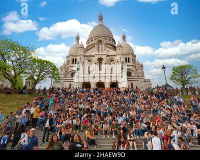 Paris, France - April 2019: Sacre Coeur Basilica Sacred Heart in Paris full of people crowded Stock Photo