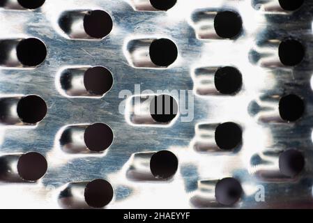 Background.: Textured gray sharp metal iron grating, grid or stainless steel grate. Kitchen metallic grater for cooking cheese or fruits or vegetable Stock Photo