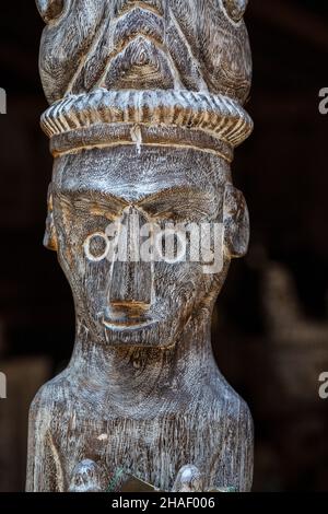 Balinese ancient wooden statue on street in Ubud, island Bali, Indonesia. These figures of the gods protect the house from evil spirits. Close up Stock Photo