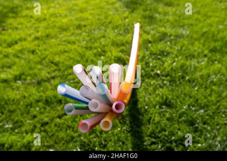empty tubes for fiber optic cables come out of the ground on a meadow Stock Photo