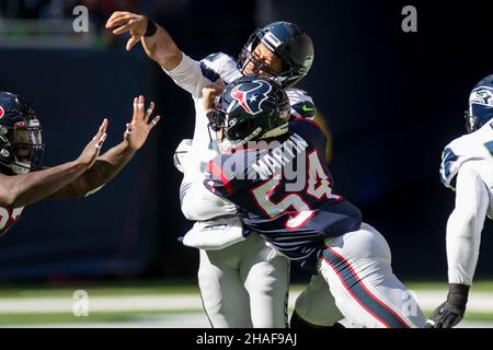 January 9, 2022: Tennessee Titans quarterback Ryan Tannehill (17) escapes a  would-be sack by Houston Texans defensive end Jacob Martin (54) during an  NFL game on Jan. 9, 2022 in Houston, Texas.