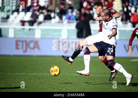 Turin, Italy. 12th Dec, 2021. Mergim Vojvoda of Torino FC and Lorenzo De Silvestri Bologna FC in action during the Serie A 2021/22 match between Torino FC and Bologna FC at Olimpico Grande Torino Stadium on December 12, 2021 in Turin, Italy Photo ReporterTorino Credit: Independent Photo Agency/Alamy Live News Stock Photo