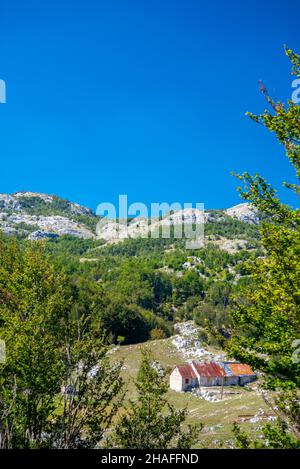 Sunny weather in late summer,southwest Montenegro,beautiful special area for Montenegrin people.Small rural buildings in the foreground surrounded by Stock Photo