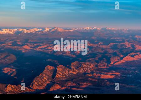 Aerial view of the Rocky Mountains covered by snow on sunset Stock Photo