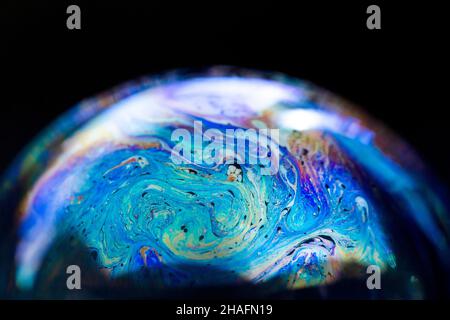 Abstract pattern, multicolored chaotic texture inside of the soap bubble, closeup Stock Photo