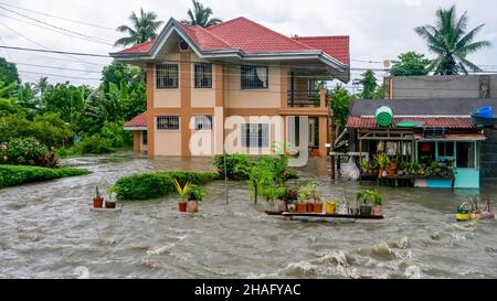 Baco, Oriental Mindoro, Philippines - July 23, 2021. Heavy monsoon rain linked to Typhoon In-fa causes severe flooding on property near Calapan City.