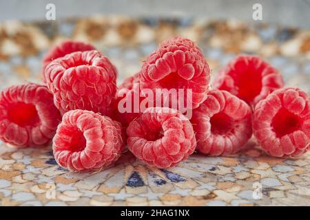 Fresh raspberries lying on plate for eating Stock Photo