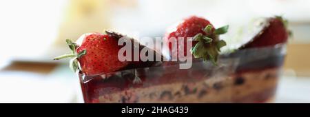 Chocolate puff cake with strawberries on white plate closeup Stock Photo