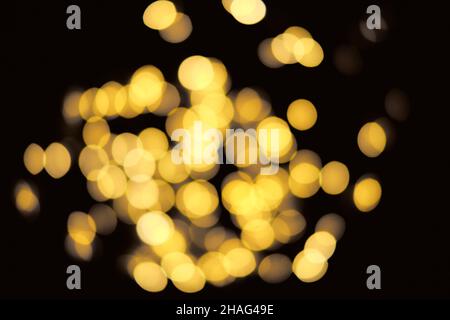 Blurred golden festive lights. Blurred backdrop for holidays and parties. Christmas Party concept Stock Photo