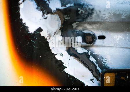 Burned car. abstract close up of the melted parts of a fire damaged Renault Kangoo a multi purpose commercial vehicle. Photographed in Jaffa, Israel Stock Photo