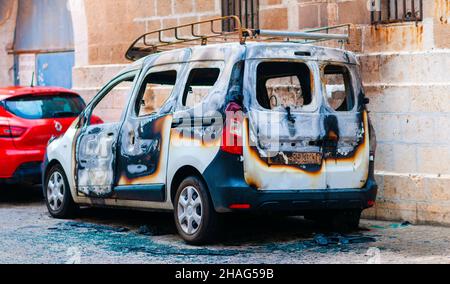 Burned car. the remains of a fire damaged Renault Kangoo a  multi purpose commercial vehicle. Photographed in Jaffa, Israel Stock Photo