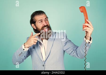 New phone and improved. Male talking on landline phone. vintage technology in modern life. line is busy. Fellow On The Phone. young man talking on Stock Photo