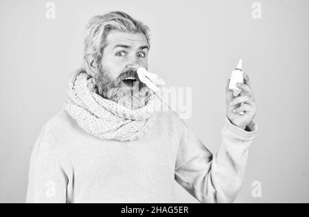 free your stuffy nose. no addiction to medicals. coronavirus from china. happy hipster presenting best remedy. Nasal drops plastic bottle. pandemic Stock Photo