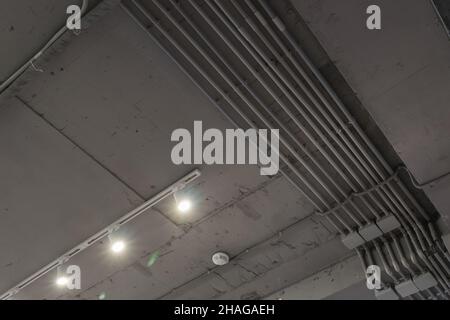 Abstract loft interior of concrete grey ceiling with air ventilation and security camera. Interior architecture and ceiling design of industrial loft Stock Photo
