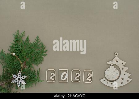 2022 wooden eco christmas. Minimalistic gray-green design of a Christmas card with a date. The concept of a holiday, the advent of the New Year. Zero