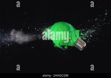 green light bulb shattering. high speed photography Stock Photo