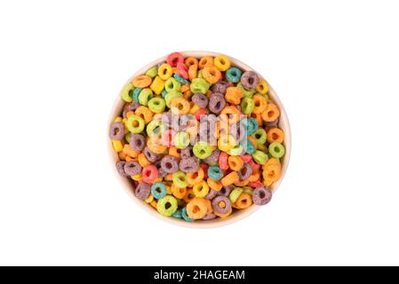 Colorful rings cereal spill out into a bowl. Breakfast. Isolated on a white background. Stock Photo