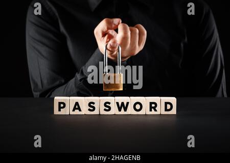 Male hand with a padlock over the wooden blocks with the word password. Data, internet security or cybersecurity concept. Stock Photo