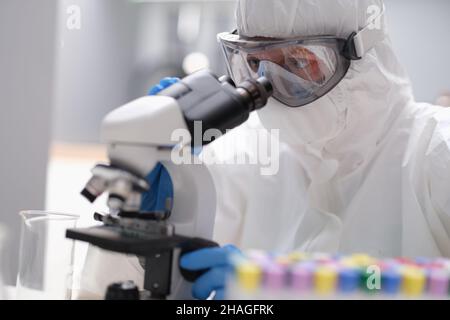 A man in looks through an X-ray microscope Stock Photo