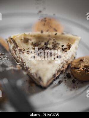 Vertical shot of homemade chocolate chip cookie dough cheesecake on a plate Stock Photo