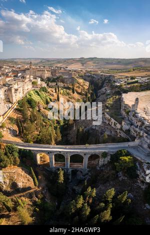 View of the old town center of Gravina and the acqueduct bridge over the canyon. Province of Bari, Apulia, Italy, Europe. Stock Photo