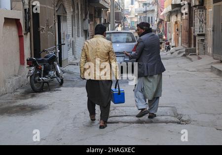 RAWALPINDI, Pakistan - December 13: A health worker administers polio vaccine to a child during an anti-polio drive in Rawalpindi on December 13, 2021 Stock Photo