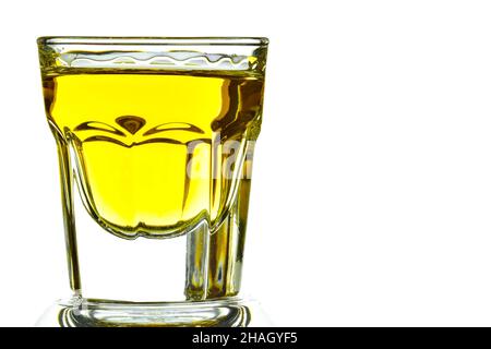On a white background on the left side of a glass with whiskey close-up. On the right is an empty space for an inscription Stock Photo