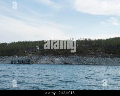 View of Anonjalmme over lake Akkajaure, saami setllement with group of hiker people waiting for the boat to Ritsem. Start point of Padjelantaleden Stock Photo